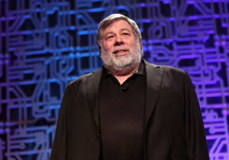 Steve Wozniak poses a picture with in suit.